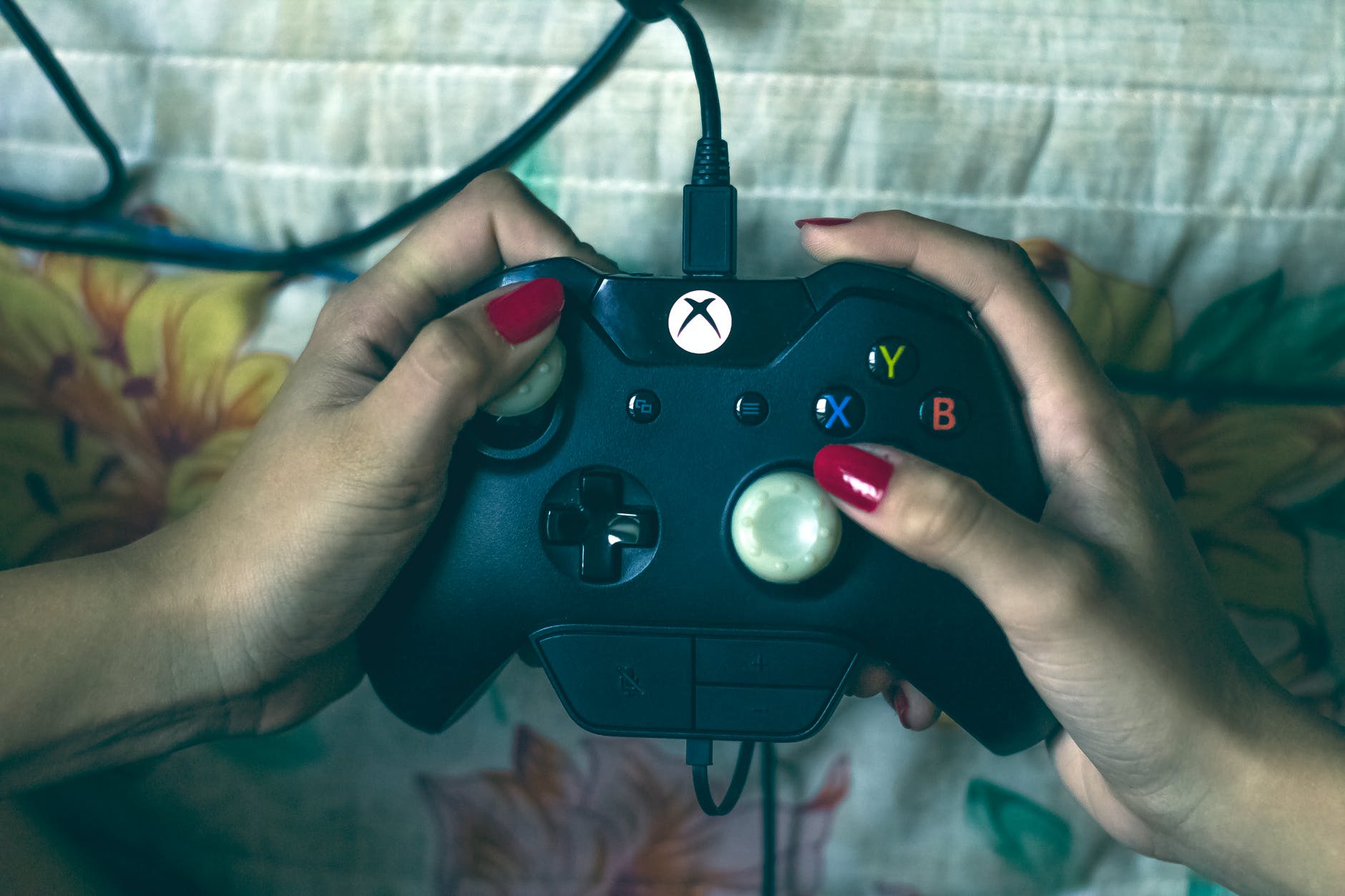person holding microsoft xbox one controller playing video game